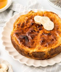 a baked dessert on a white plate with bananas