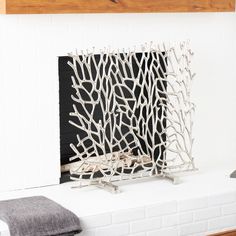 a fire place with white branches on it