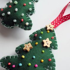 two felt christmas tree ornaments on a table