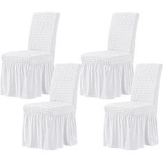 four white chairs with ruffled covers on them