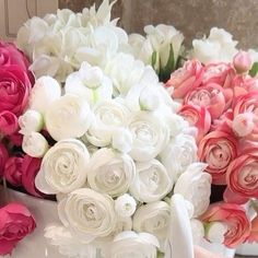 there are many different types of flowers in the vases on the table, one is pink and white