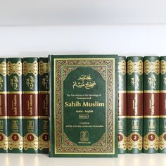 a row of green books sitting next to each other on top of a white table