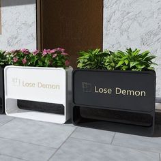 three planters with flowers in them on the sidewalk