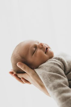 a woman holding a baby in her arms