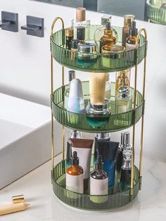 a three tiered shelf with bottles and cosmetics on it next to a bathtub