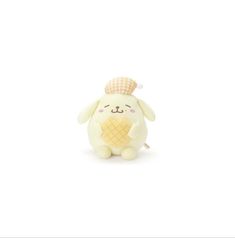 a small stuffed animal with an ice cream cone on it's head, sitting in front of a white background