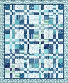 a blue and white quilt with squares on the front, in shades of teal