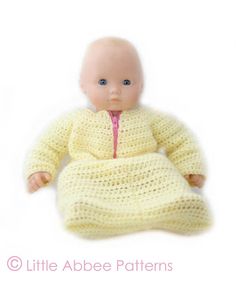 a baby doll wearing a yellow knitted outfit