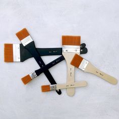 five paint brushes arranged on top of each other in the shape of a rectangle