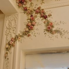 the wall is decorated with flowers and vines