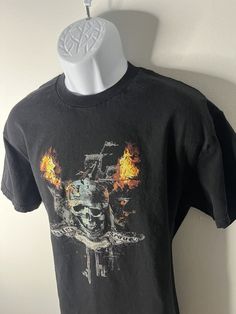 Great condition; no flaws noted. This vintage Pirates of the Caribbean Tennessee River t-shirt is a must-have for any fan of the movie franchise. The black shirt features a solid pattern, short sleeves, and a crew neckline, making it a comfortable and stylish addition to any wardrobe. It is a size large and has a regular fit, with a size type of regular. The shirt is in excellent condition and has a vintage feel to it. The shirt is perfect for any occasion, whether it's a casual day out or a the The Carribean, Tennessee River, Black Short Sleeve Shirt, Movie Memorabilia, Pirates Of The Caribbean, The Caribbean, Themed Party, Solid Pattern, Black Shorts