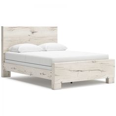 the bed frame is made from wood and has white sheets