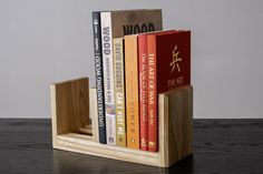 a wooden book holder with four books in it