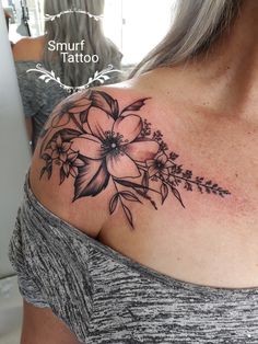 a woman with a flower tattoo on her shoulder