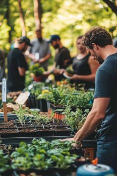 a group of people working in an outdoor garden area with plants and seeding equipment