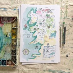 a watercolor and ink drawing of a map in an artist's box