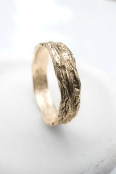 Nature wedding ring that is handcrafted in 14k solid gold.  This rustic wedding ring has a tree bark texture yet is smoothe to  touch with no snagging.  The nature inspired ring makes a unique men's or women's wedding band.  Perfect for a nature or tree lover!    This tree ring is available in solid 14k or 18k yellow, white, or rose gold.  It's also available in sterling silver.   The ring has a beautiful giant sequoia carving on the inside.  Giant Sequoias symbolize longevity, power, strength, Organic Wedding Ring, Nature Inspired Wedding Bands, Rustic Wedding Ring, Nature Wedding Ring, Giant Sequoia, Bark Ring, Textured Wedding Band, Tree Bark Texture, Rustic Wedding Rings