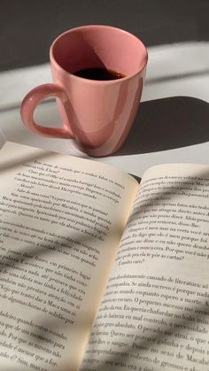 an open book with a cup of coffee on it