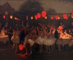 a group of people standing around a table with paper lanterns