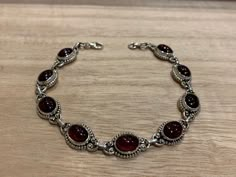 Lovely garnet and sterling silver bracelet. The bracelet has 9 individual garnet in an oval shape.  The bracelet measure 21 cm long and it is almost 0.8 cm wide. The bracelet can be  easily  adjusted from 21 cm to 17 cm.  The high quality of our stones is what it makes this bracelet so precious.  A perfect present for her on any occasion St Valentine Day, Birthday, Anniversary, Travelling or Christmas. Your bracelet will be pack in our lovely Kallpa bag. If the destination is outside UK the pack Edgy Jewelry, Red Bracelet, Present For Her, St Valentine, Garnet Bracelet, Red Bracelets, Garnet Jewelry, Dope Jewelry, Bracelet Chain