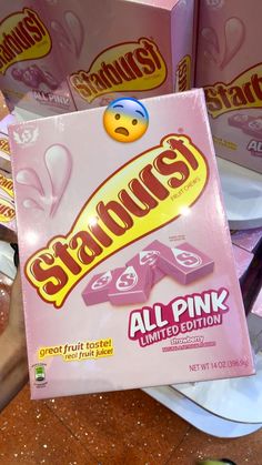 someone holding up a box of starburst all pink limited cotton candy