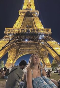 a woman sitting in front of the eiffel tower