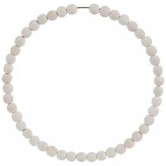 a white beaded necklace on a white background