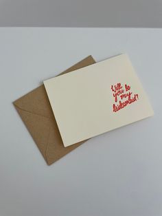 two cards with red ink on them sitting next to each other