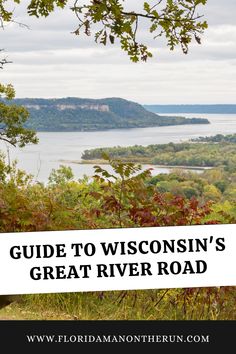 a sign that says guide to wisconsin's great river road with the water in the background