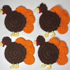 four crocheted turkey coasters on a white surface