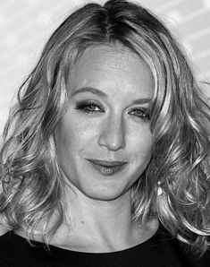 a black and white photo of a woman with wavy hair