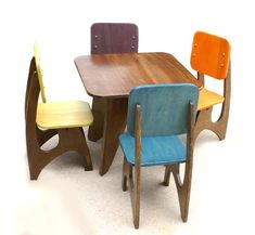 three wooden chairs and a table with different colors