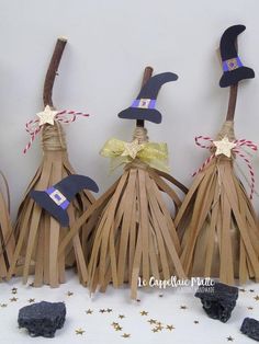 three witches made out of sticks and paper