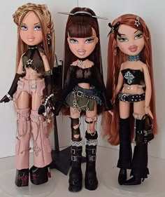 three dolls are standing next to each other