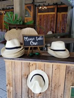 hats are on display in front of a sign