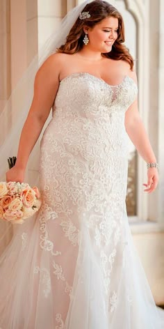 a woman in a wedding dress holding a bouquet and posing for the camera with her hand on her hip