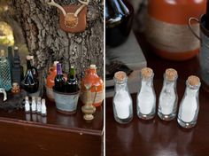 there are bottles and other items on the table next to each other, including an antler's head