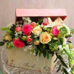 a bouquet of flowers in a box on a table