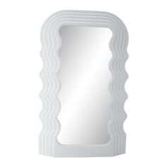 a white mirror sitting on top of a wall