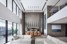 a living room filled with white furniture and lots of windows