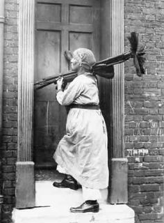 an old black and white photo of a person with a bird on his back walking out of a door