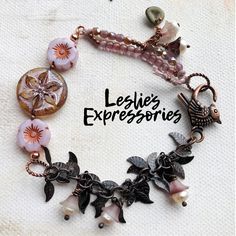 a close up of a bracelet with charms and flowers on the front, along with words that read legie's expressions