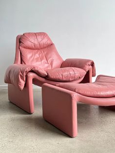 a pink leather chaise lounge chair and ottoman