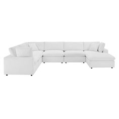 a white sectional couch with pillows on it