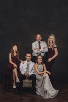 an image of a family posing for a photo in their formal dress clothes and ties