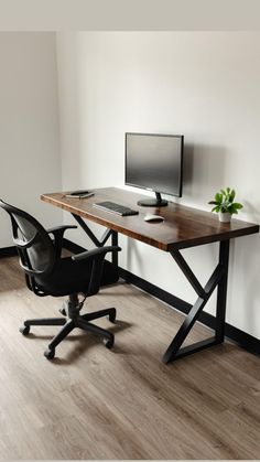 an office desk with a computer monitor, keyboard and mouse sitting on top of it