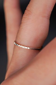 This sleek, unisex stacking ring combines minimalism with a unique hand-stamped touch. Crafted from 1mm thick square metal, it features distinctive lined notches that create subtle texture, perfect for an understated yet stylish look. Suitable for men and women alike, this handmade piece pairs effortlessly with other rings or shines beautifully on its own. Made from STERLING SILVER metal. Each individual ring measures approx. 1mm in width. This lined stacking ring catches the light beautifully a Silver Rings Dainty, Silver Rings For Women Unique, Rings For Women Unique, Rings Dainty, Interlocking Ring, Silver Rings For Women, Flat Back Earrings, Bold Rings, Symbolic Jewelry