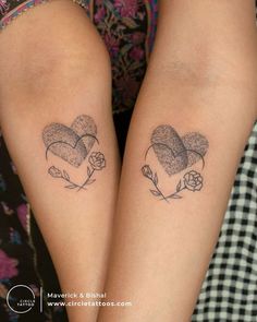 two people with matching tattoos on their legs, one has a heart and the other has a flower