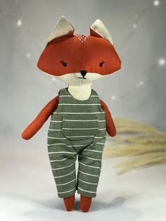 a red fox stuffed animal in striped pajamas