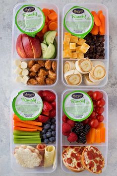 four plastic containers filled with different types of food and fruit on top of a table